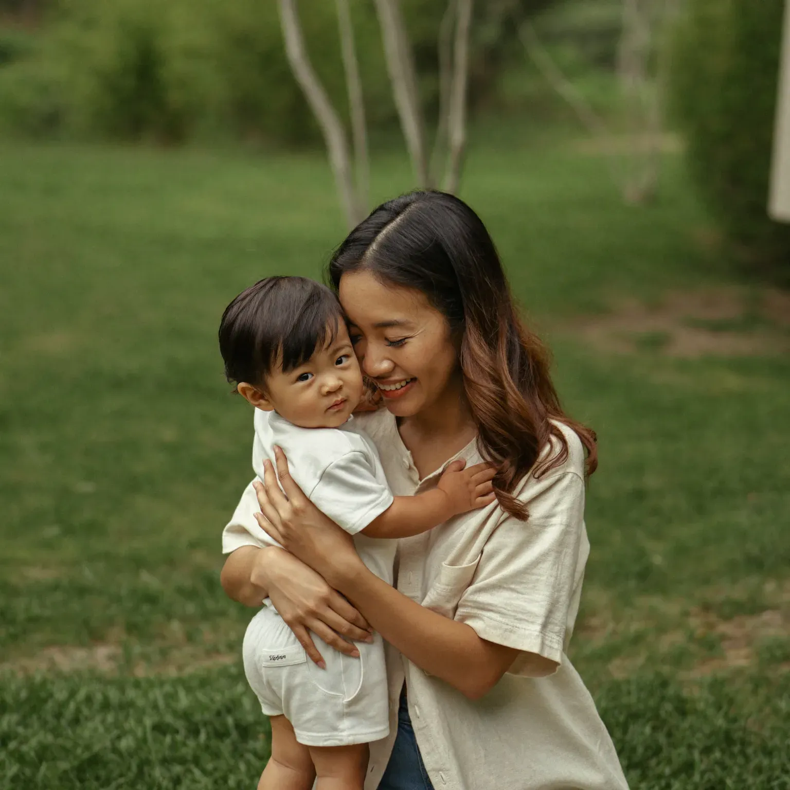 A mother holding her young child close