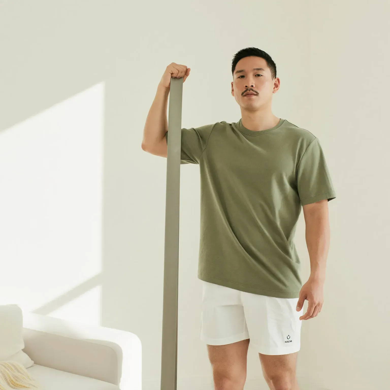 A man standing with a resistance band