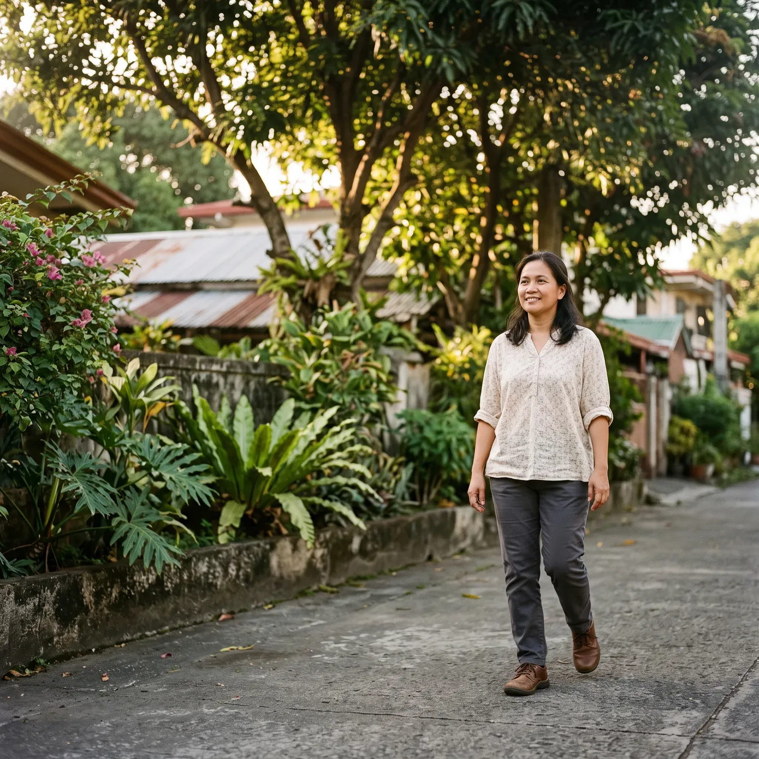 A woman walking along a tree-lined path in the morning