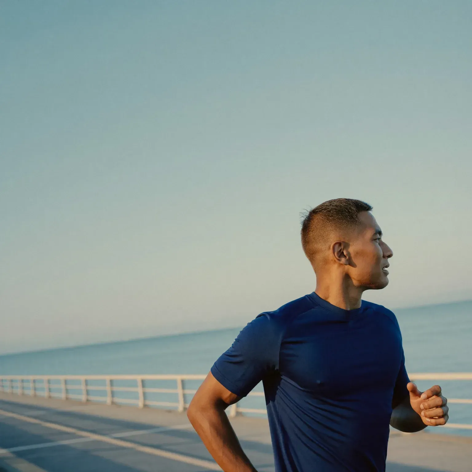 A man running along a seaside road